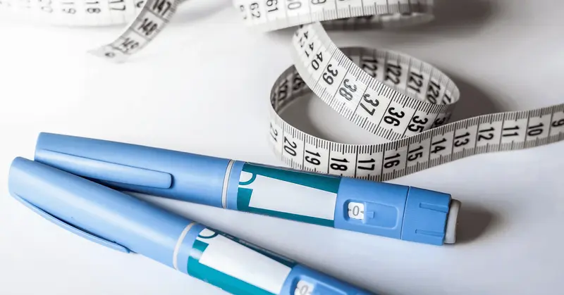 Medical pens and white measuring tape - How Can I Track My Semaglutide Progress?