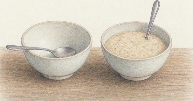 Two matching bowls of porridge, one nearly empty, one still full and untouched