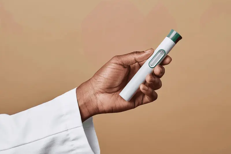 Person holding a medical injector pen - How to Qualify for GLP-1