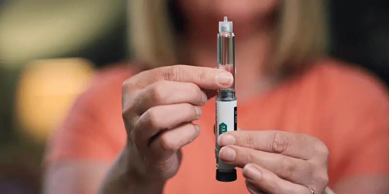 Person preparing a medical injection pen - Microdosing GLP 1