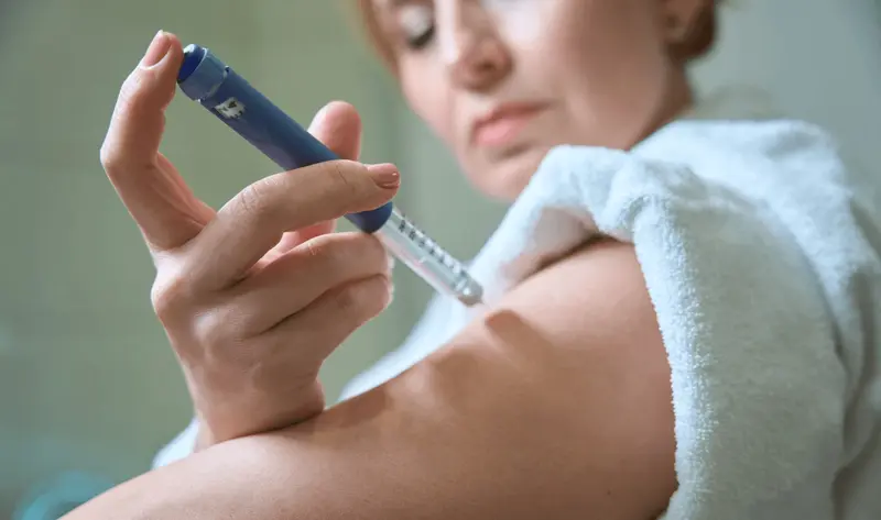 Woman injecting arm with insulin pen - How to Inject Semaglutide