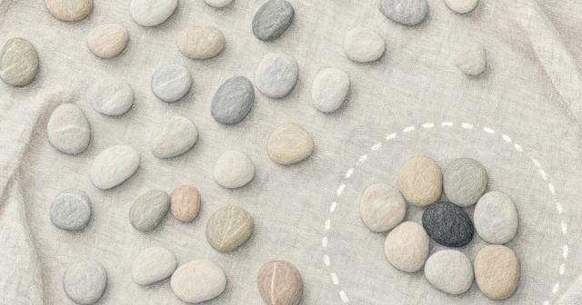Overhead view of scattered pale stones with ten set apart in a circled cluster