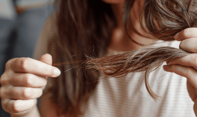 Woman examining her damaged hair ends - Does Semaglutide Cause Hair Loss