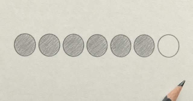 Hand-drawn row of seven circles, six shaded and one left blank, on plain paper