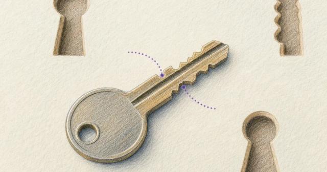 Overhead close-up of one key with dotted markers near its teeth beside three keyhole shapes