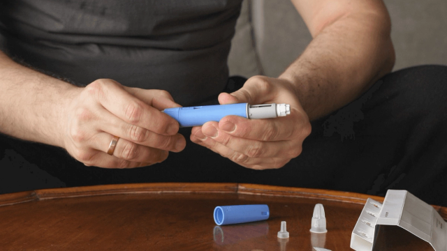 Man is holding medical injection pen - How Does Semaglutide Work