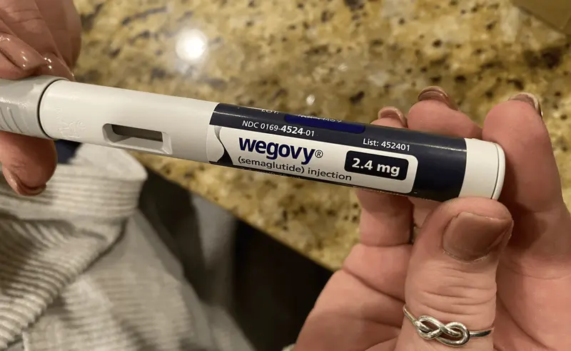 Person holding Wegovy semaglutide injection pen - Semaglutide Visceral Fat