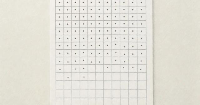 Paper grid of blank squares with ink dots dense at the top and thinning toward the bottom