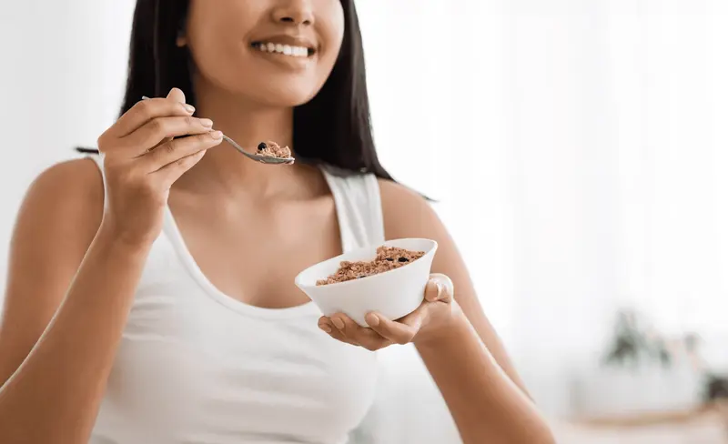Woman eating a healthy breakfast -  How Much Protein Should I Eat on Semaglutide