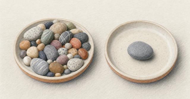 Two shallow trays side by side, one crowded with many pebbles, the other holding a single pebble