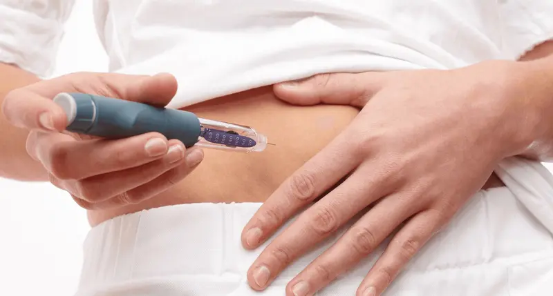 Person injecting medication into their abdomen - Can You Take Semaglutide Every Other Week for Weight Loss
