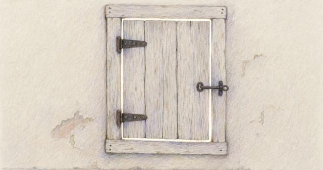 A small wooden window shutter latched shut, daylight showing around its edges