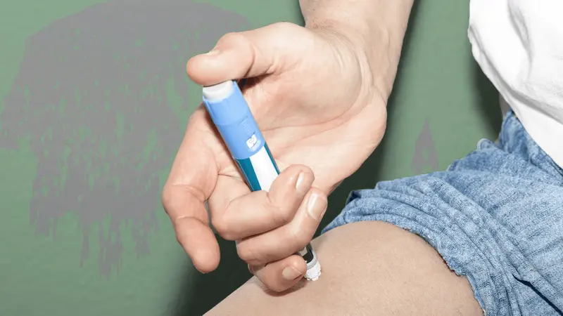 Person injecting medication into their thigh - How Old Do You Have to Be to Take Ozempic