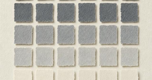 Grid of torn paper squares fading from dark grey to cream on pale linen