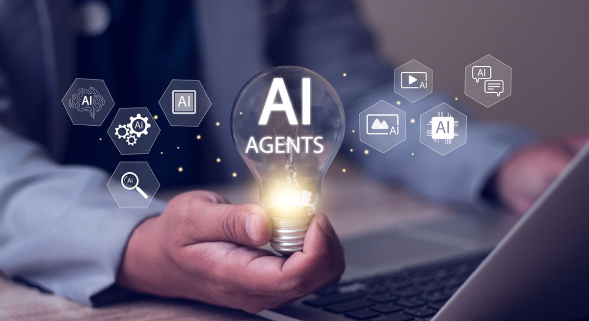 Businessman holding a lightbulb labeled ''AI agents''