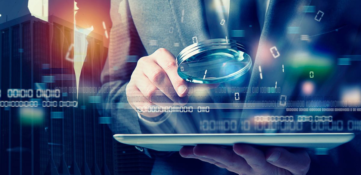 Businessman using a tablet to review an AI in account-based experience strategy.