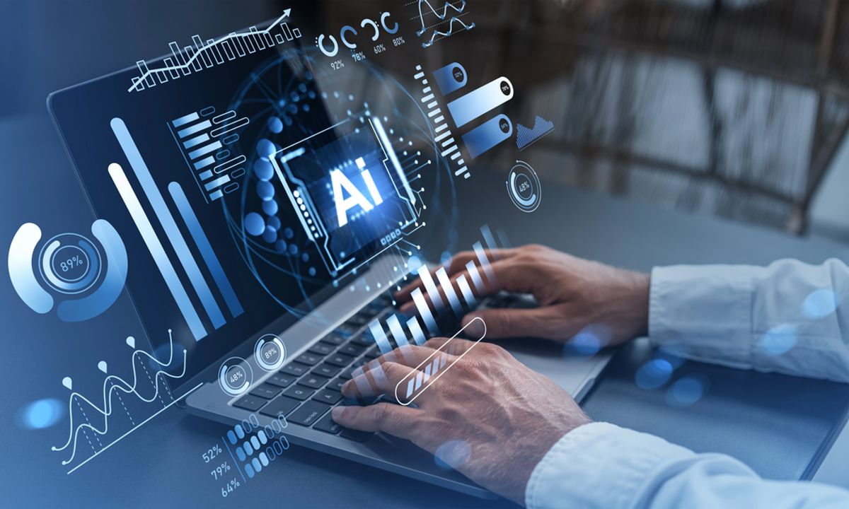 Person typing on a laptop and using AI-powered scoring tools
