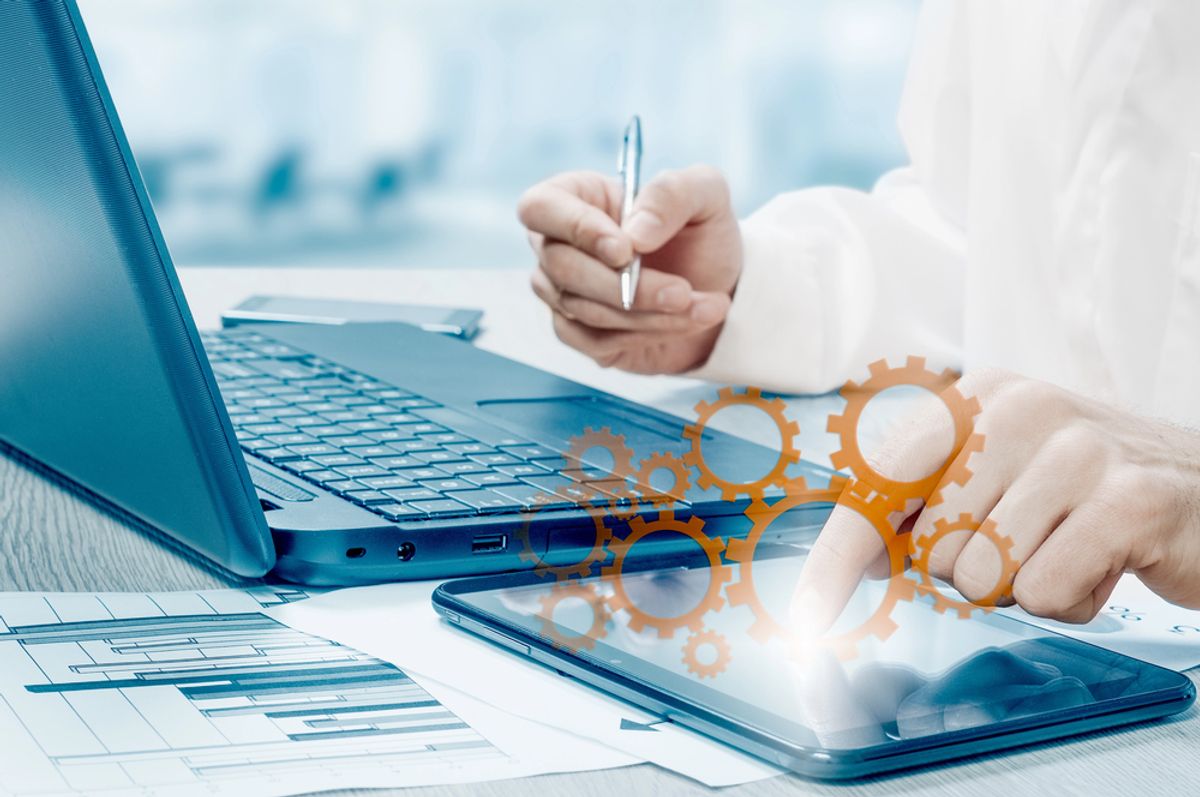 Person using a laptop to work on their process optimization methods.
