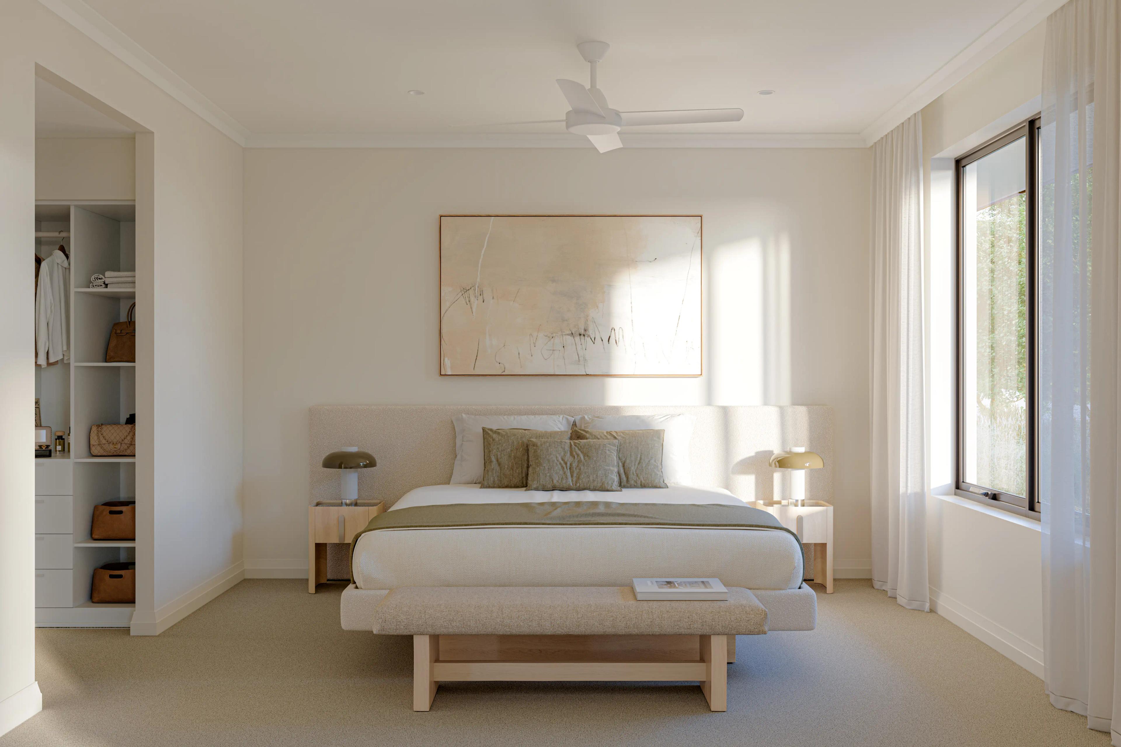 Bedroom of the villa looking directly at the queen size bed, the window on the right letting in natural sunlight. A beautiful artwork in the centre of the room on the wall and the walk in wardrobe to the left. Warm, neutral colour palettes.