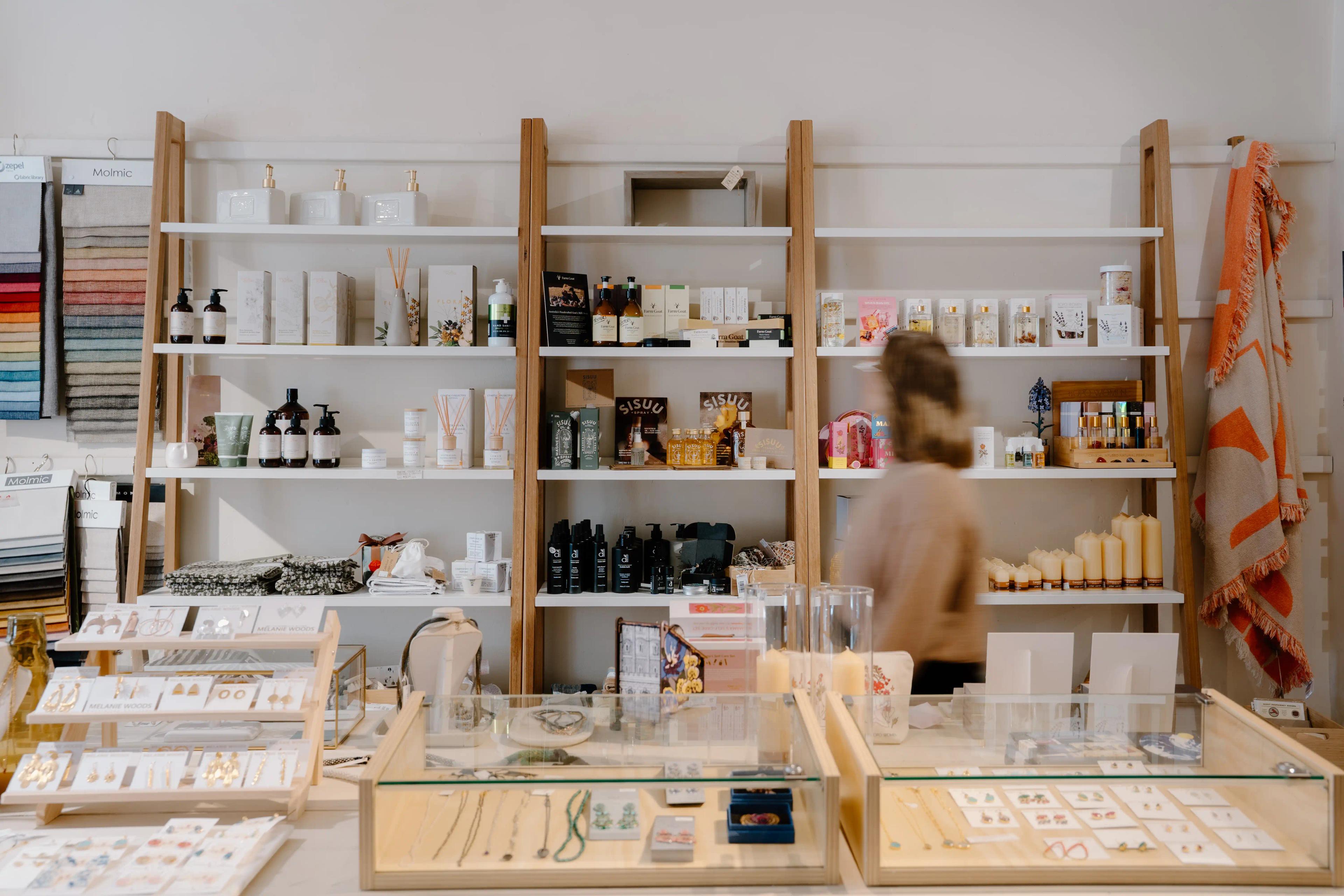 Inside the Mossy Store in Moss Vale, tall shelves along the wall displaying products and glass cabinets with jewellery.