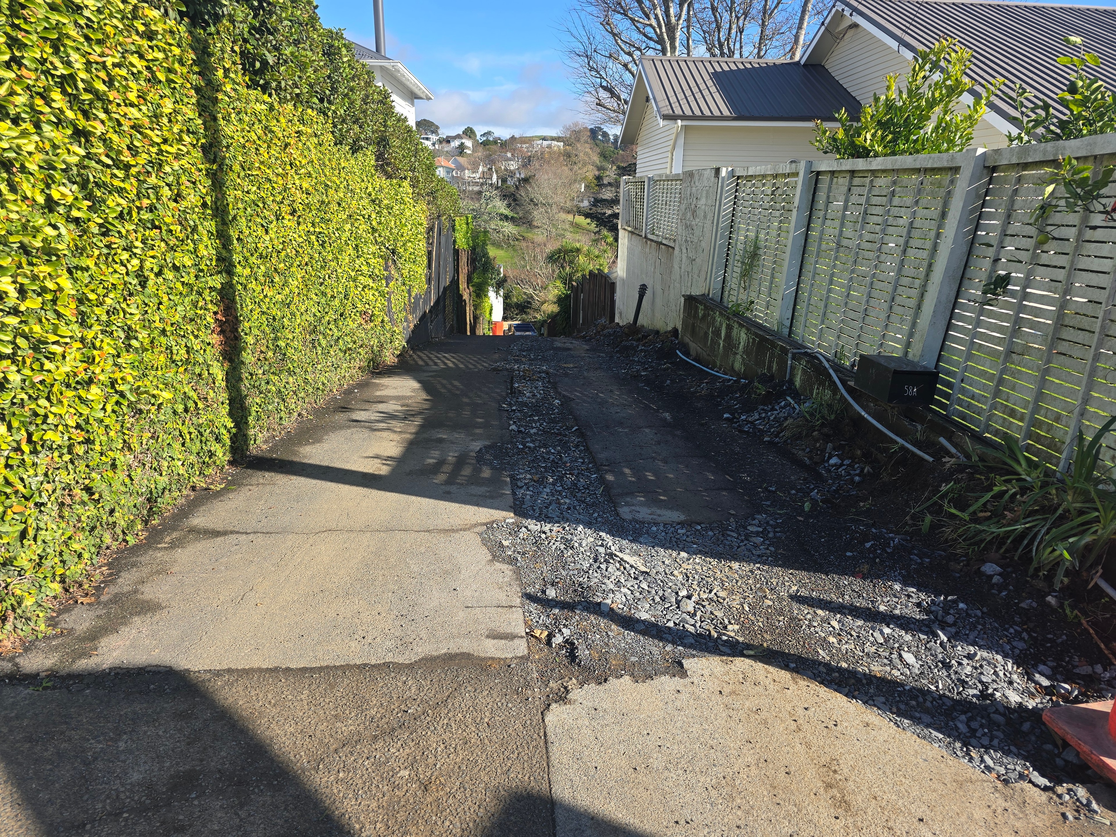 Shared driveway broken out to basecourse with the old concrete still in place alongside