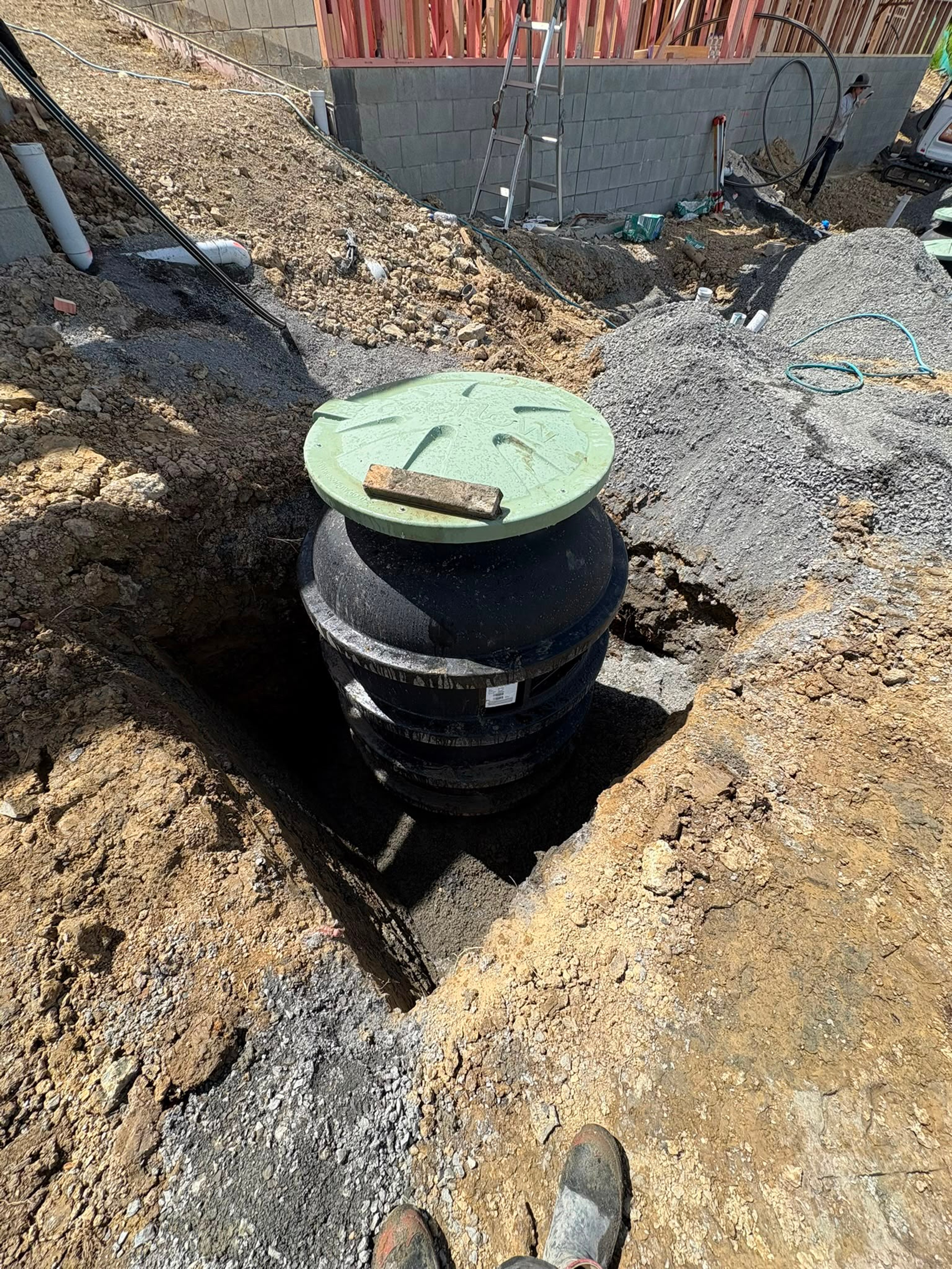 Inspection chamber riser set into the ground before backfilling