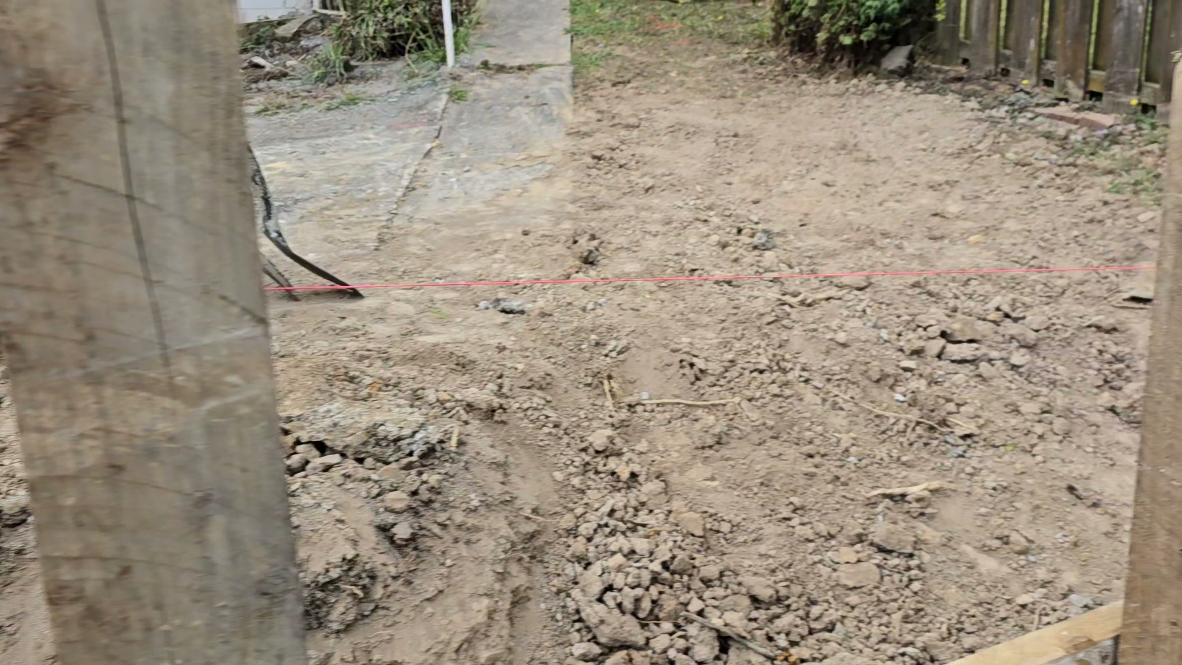 Setting out a retaining wall line across stripped ground