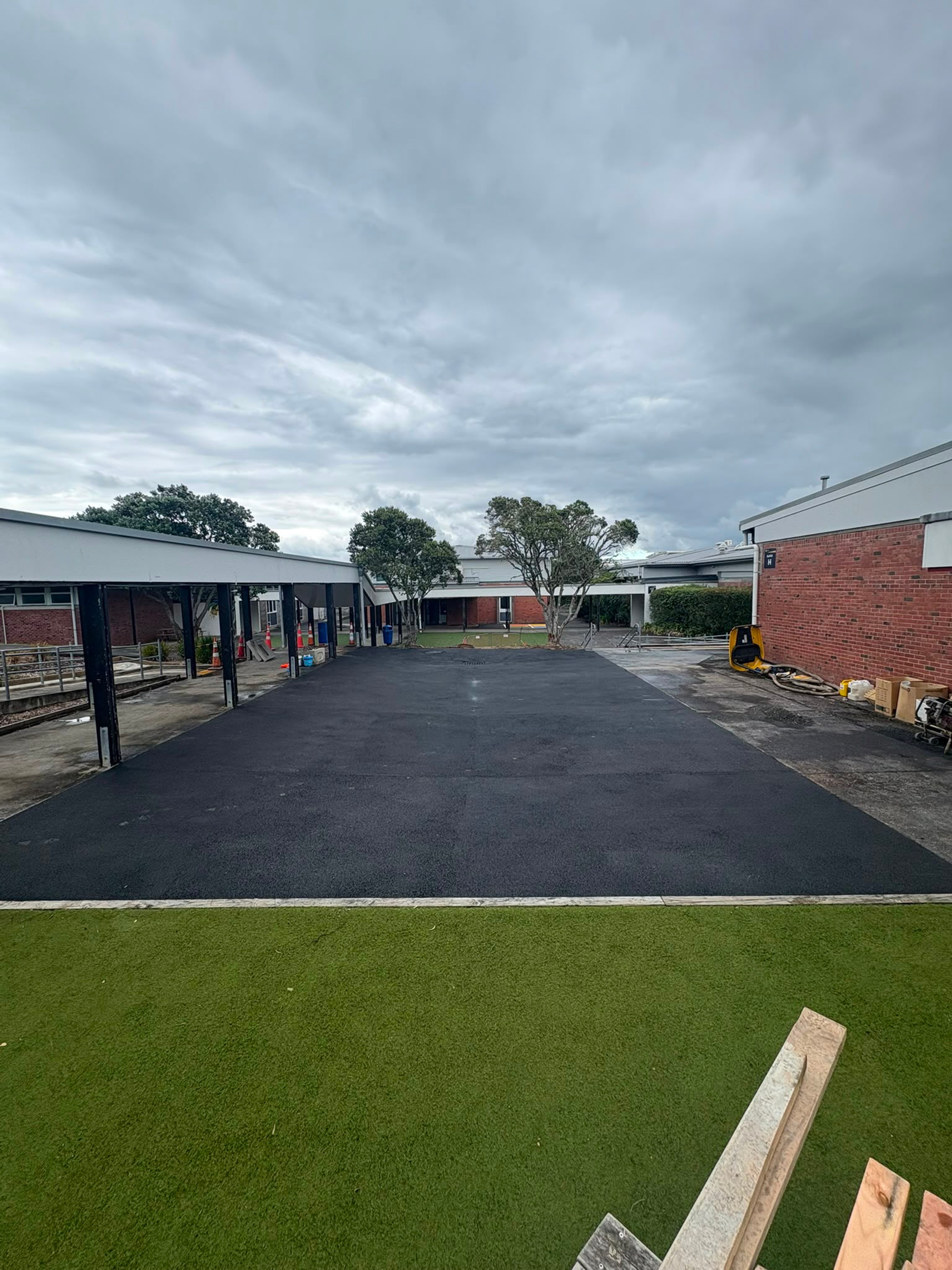 Finished asphalt driveway and court at a school