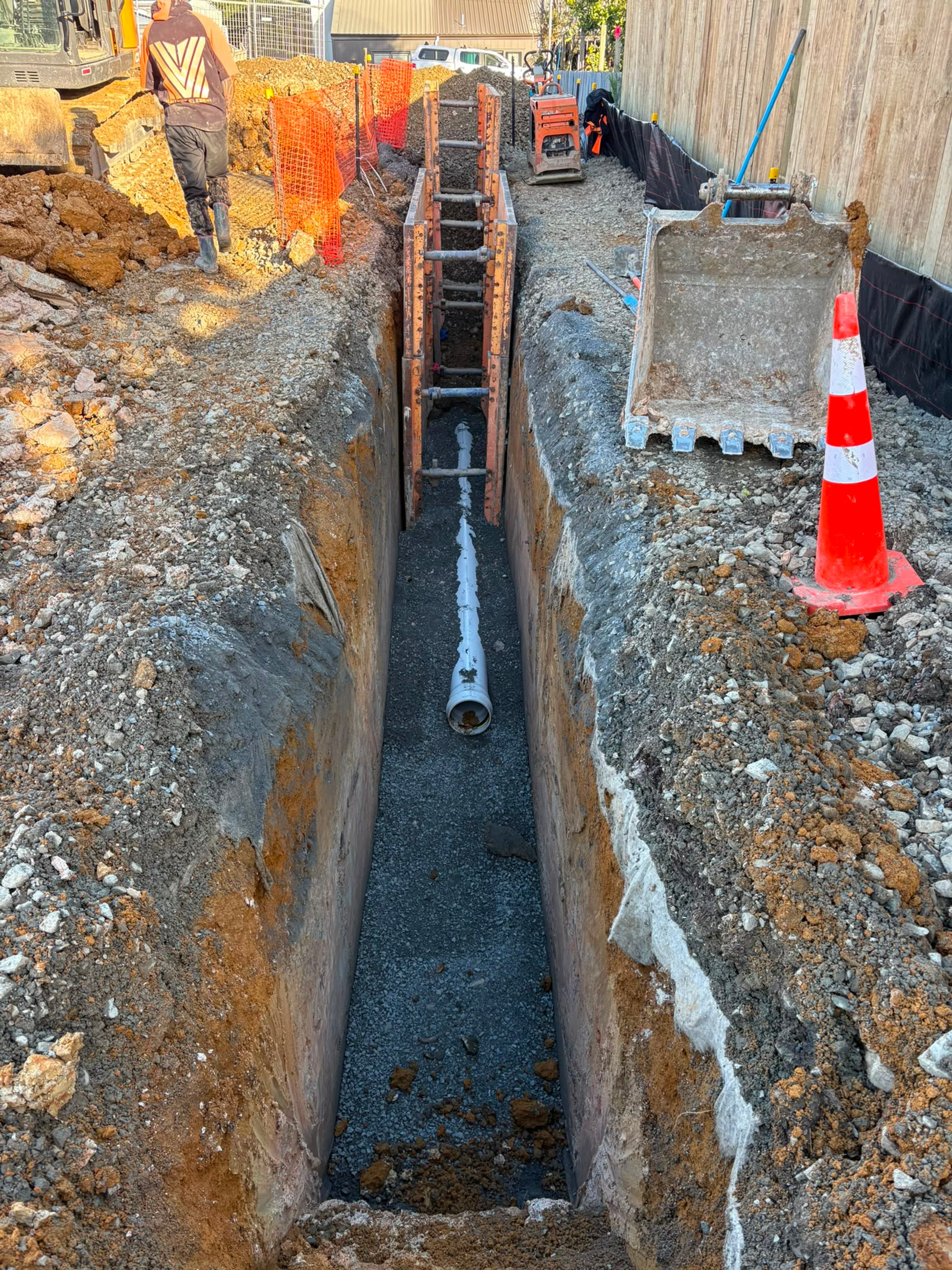 Deep shored trench with stormwater pipe bedded along the base