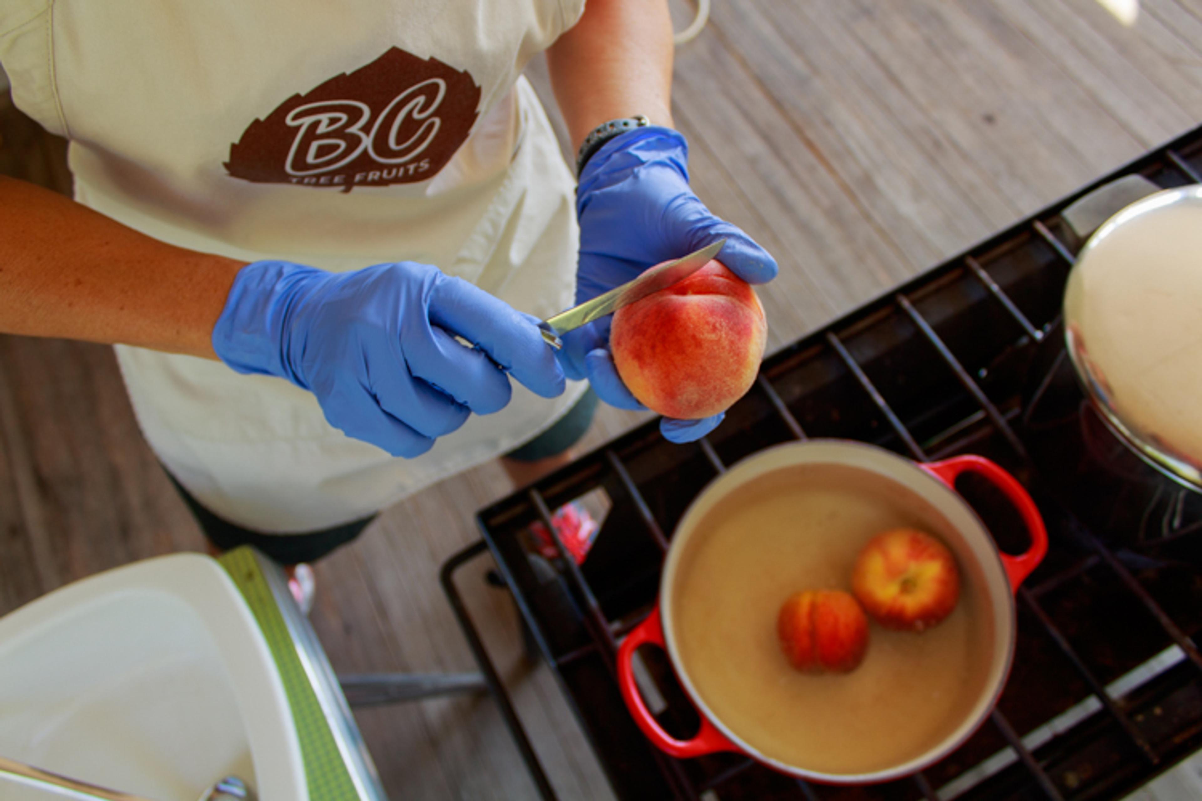 Blanch the peaches to remove the skin