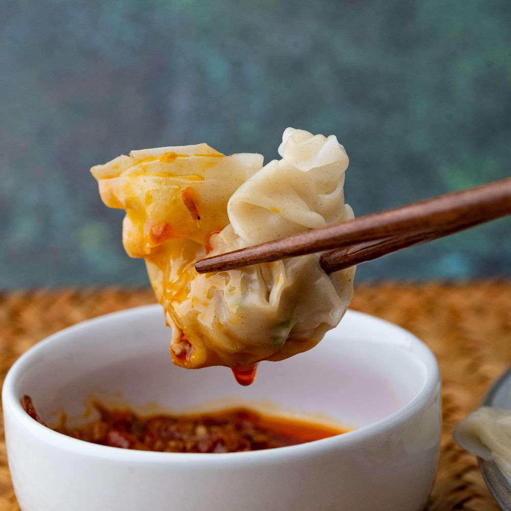 Takeout Container Of Chinese Wonton Soup With Chopsticks On A