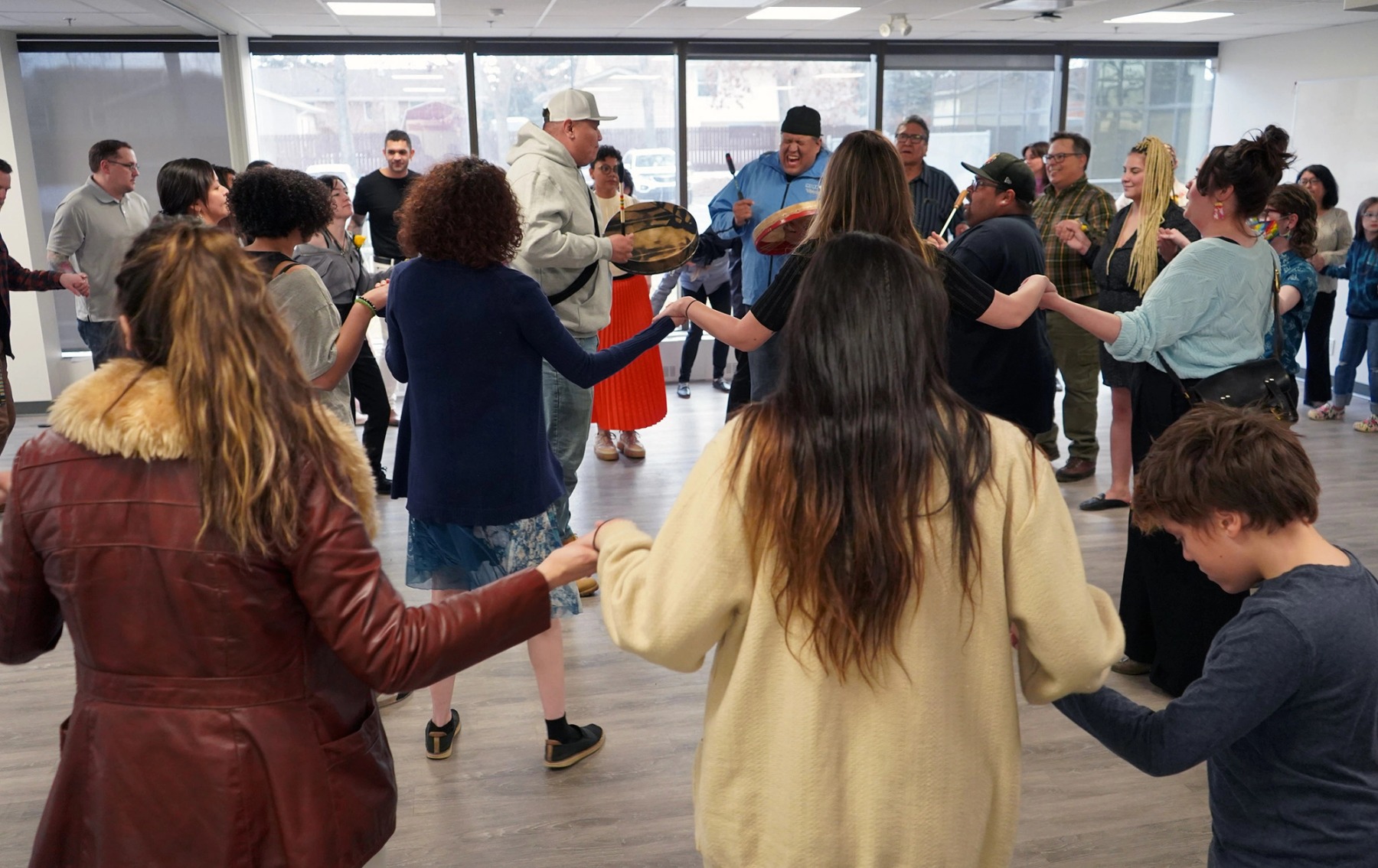 A group of people in the Digital Dreamers program participate in a traditional Indigenous dance.