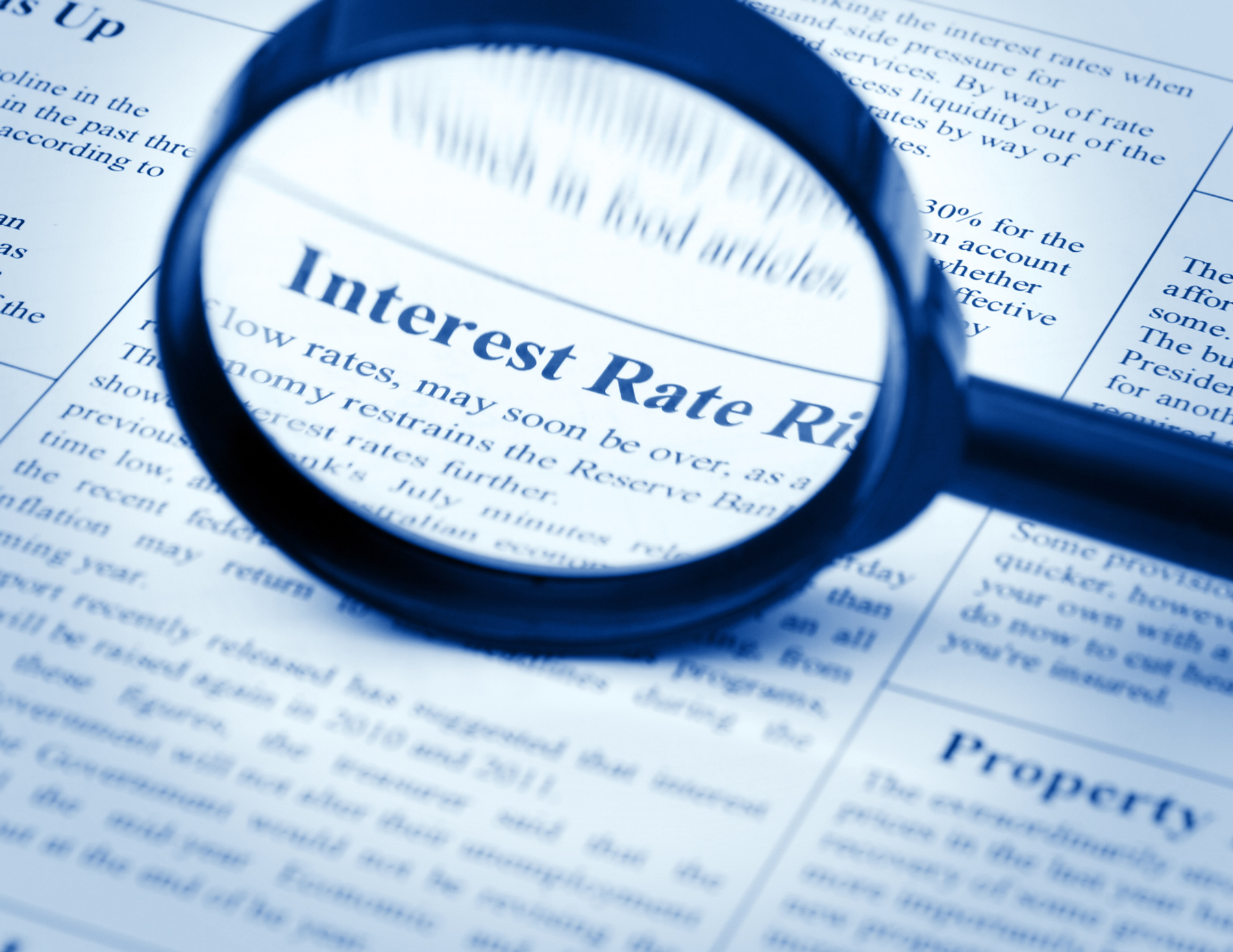 A document with a magnifying glass showing the words "interest rate".