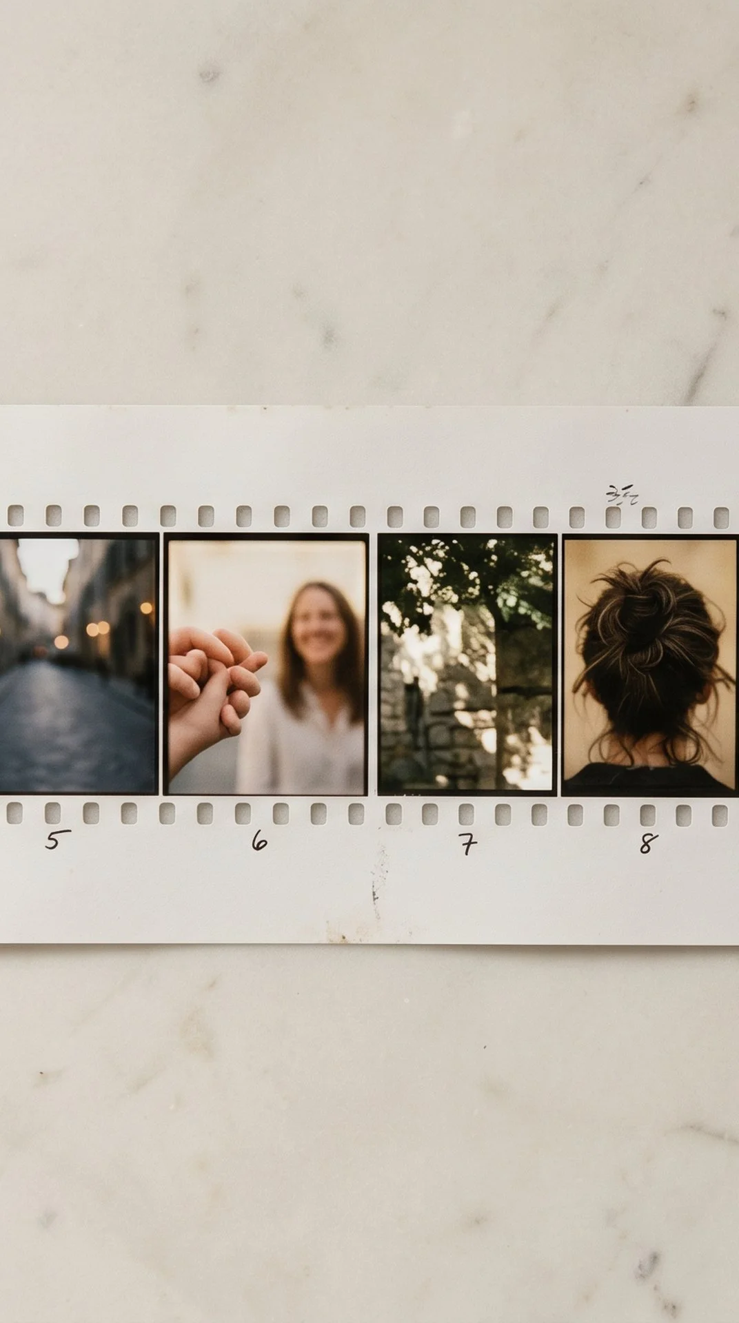 Filmstrip of aesthetic photographs on marble surface