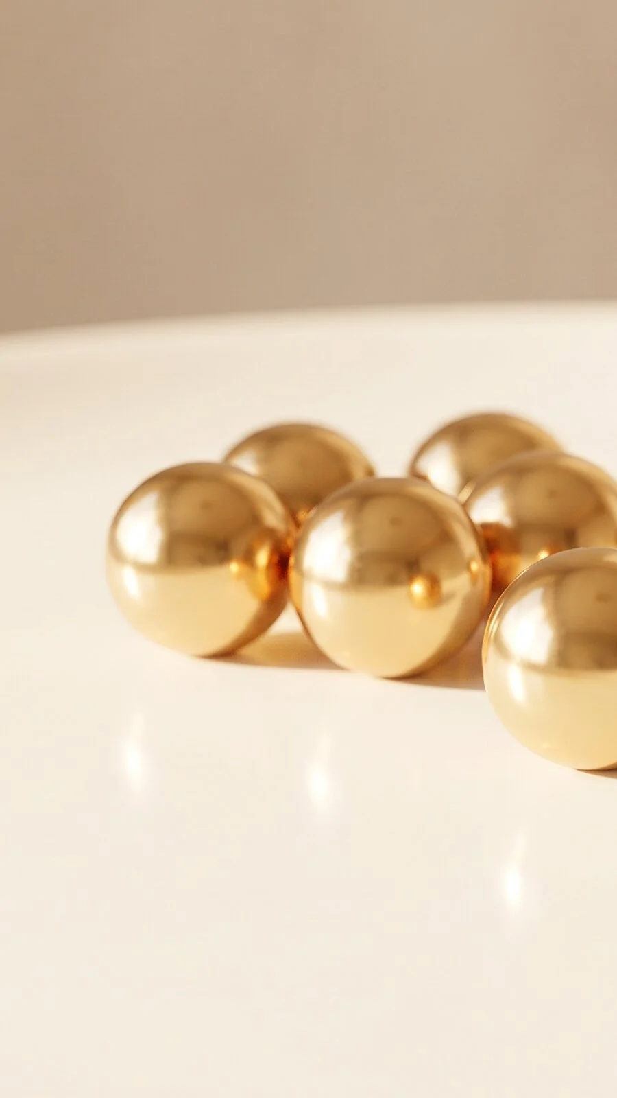 Gold spheres in warm light, one set apart.