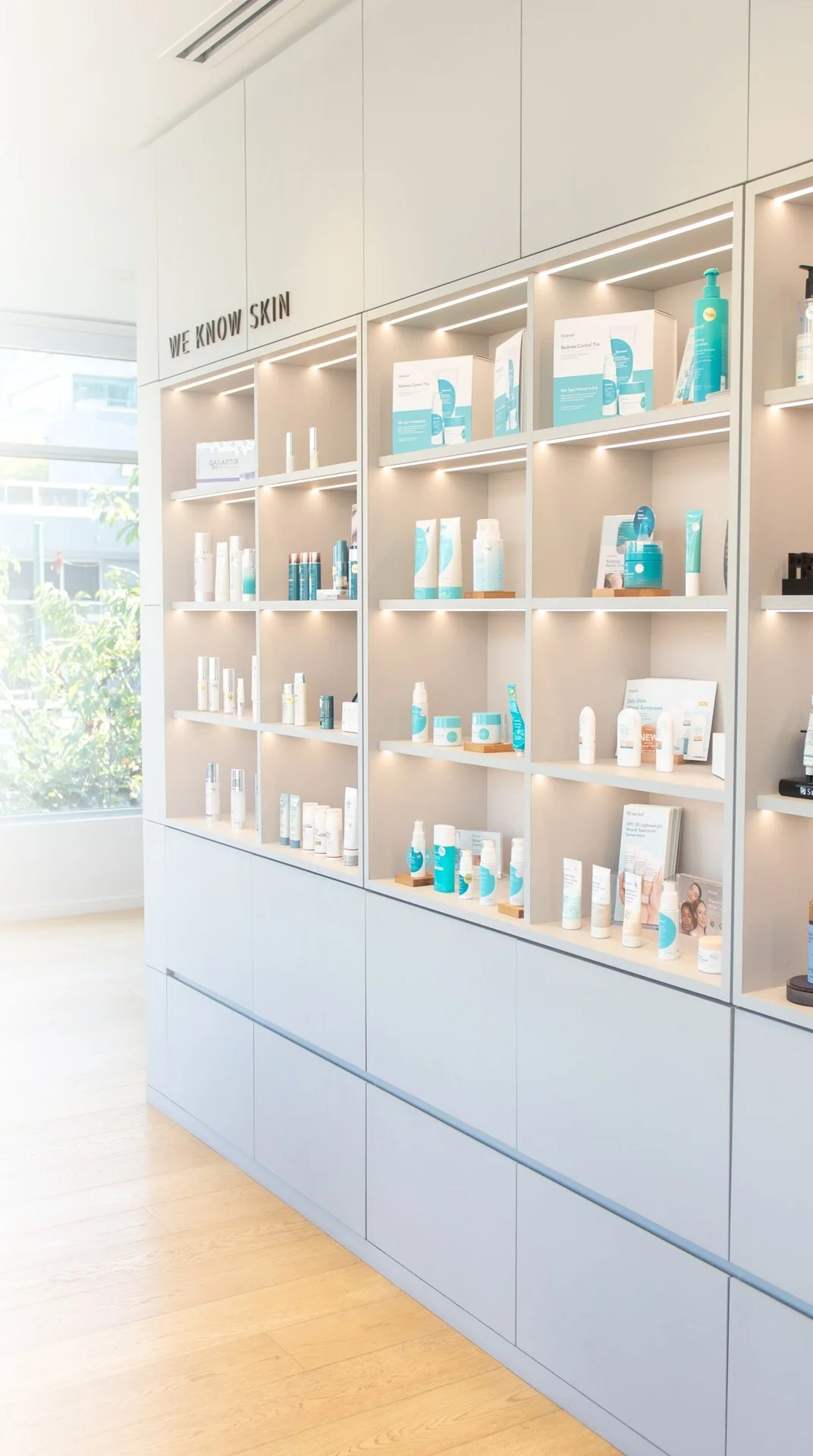 A lit clinic skincare shelving wall labelled Prevent, Protect and Correct.