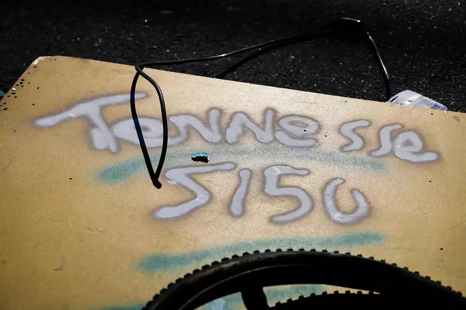 A board spray painted "Tennesse" [sic], is a piece of the dwelling that Eddie and Lindsay shared. Tennessee was Eddie's nickname, and he had 51-50 tattooed on his shoulders (Photo by Gabrielle Lurie for The Chronicle).