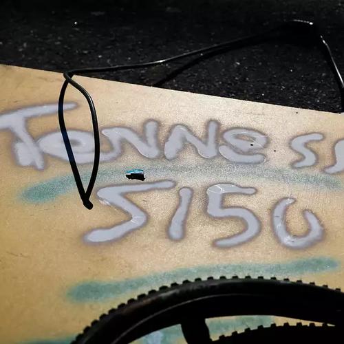 A board spray painted "Tennesse" [sic], is a piece of the dwelling that Eddie and Lindsay shared. Tennessee was Eddie's nickname, and he had 51-50 tattooed on his shoulders (Photo by Gabrielle Lurie for The Chronicle).