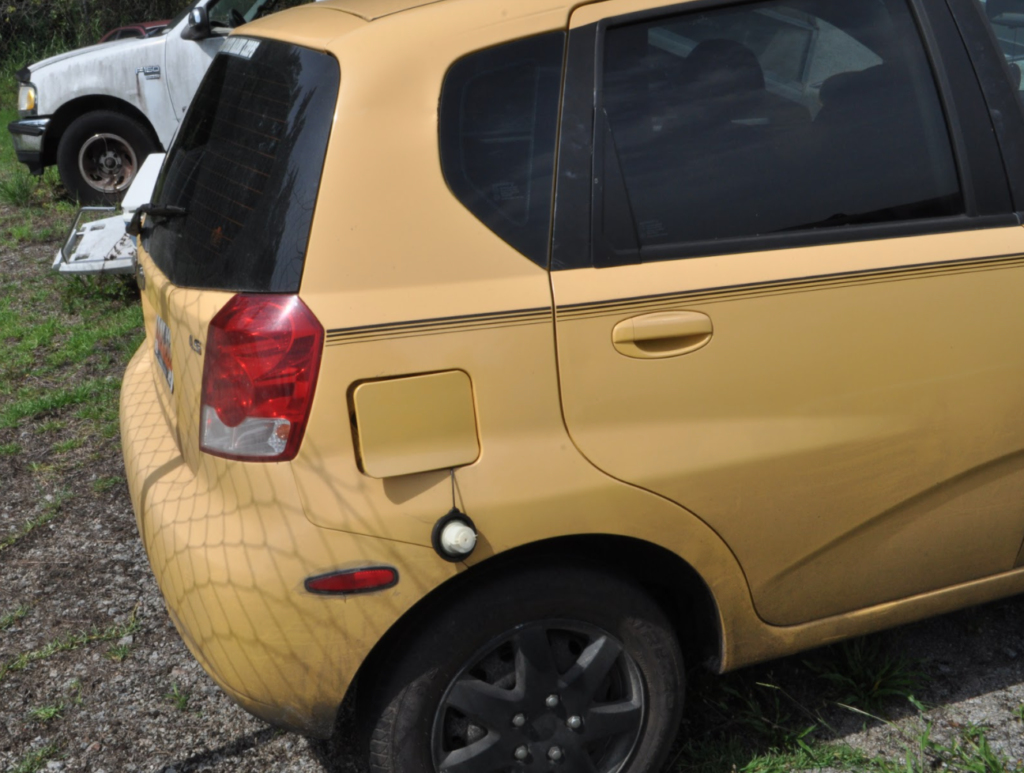 The gas door was open, and the cap was hanging when the car was discovered.