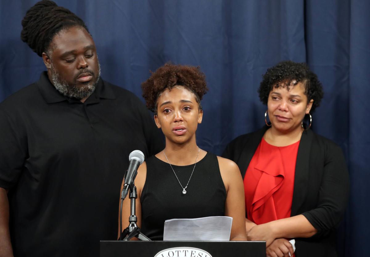 A photo of three of Sage Smith's family members speaking at a press conference.