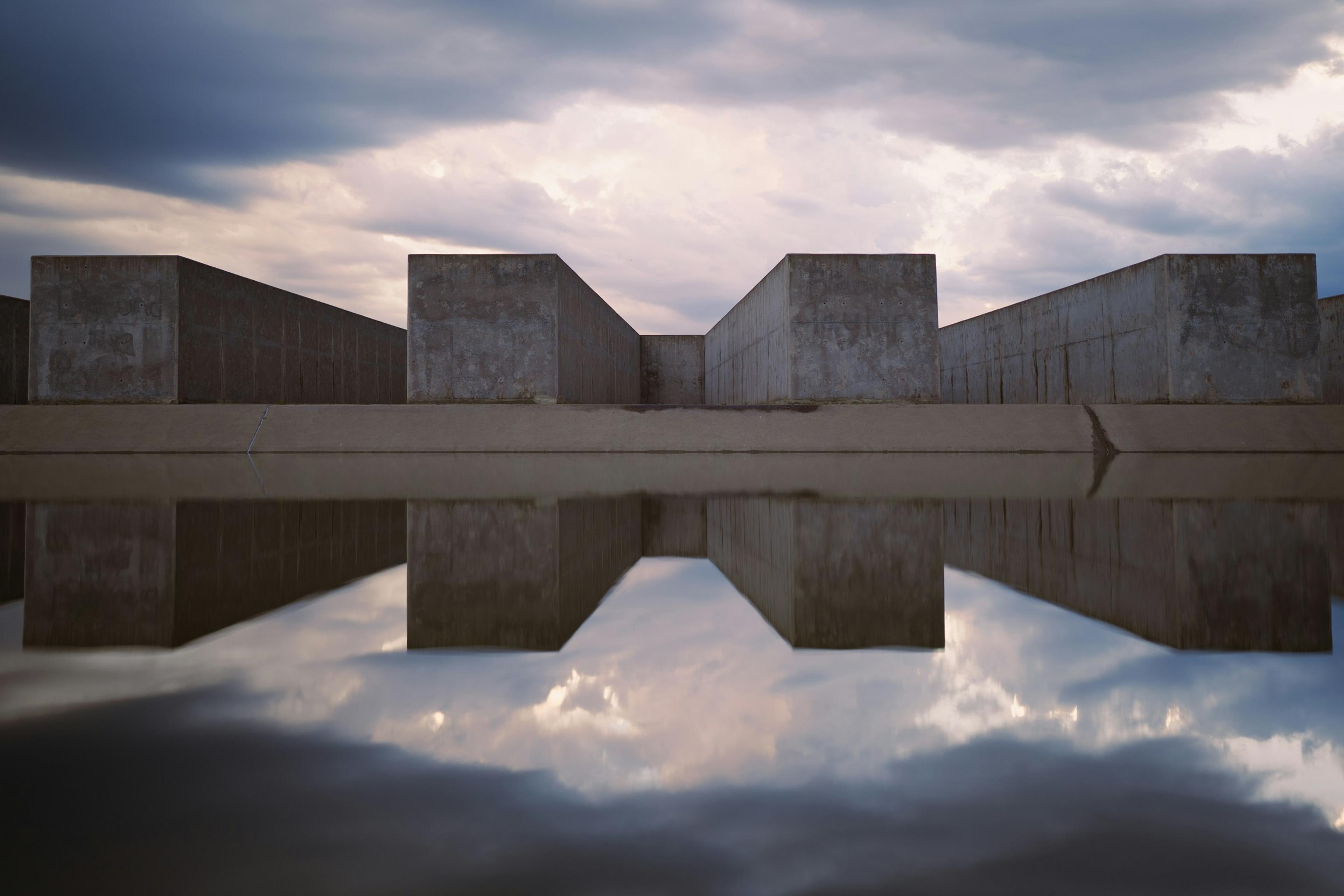 A building reflected in a still body of water