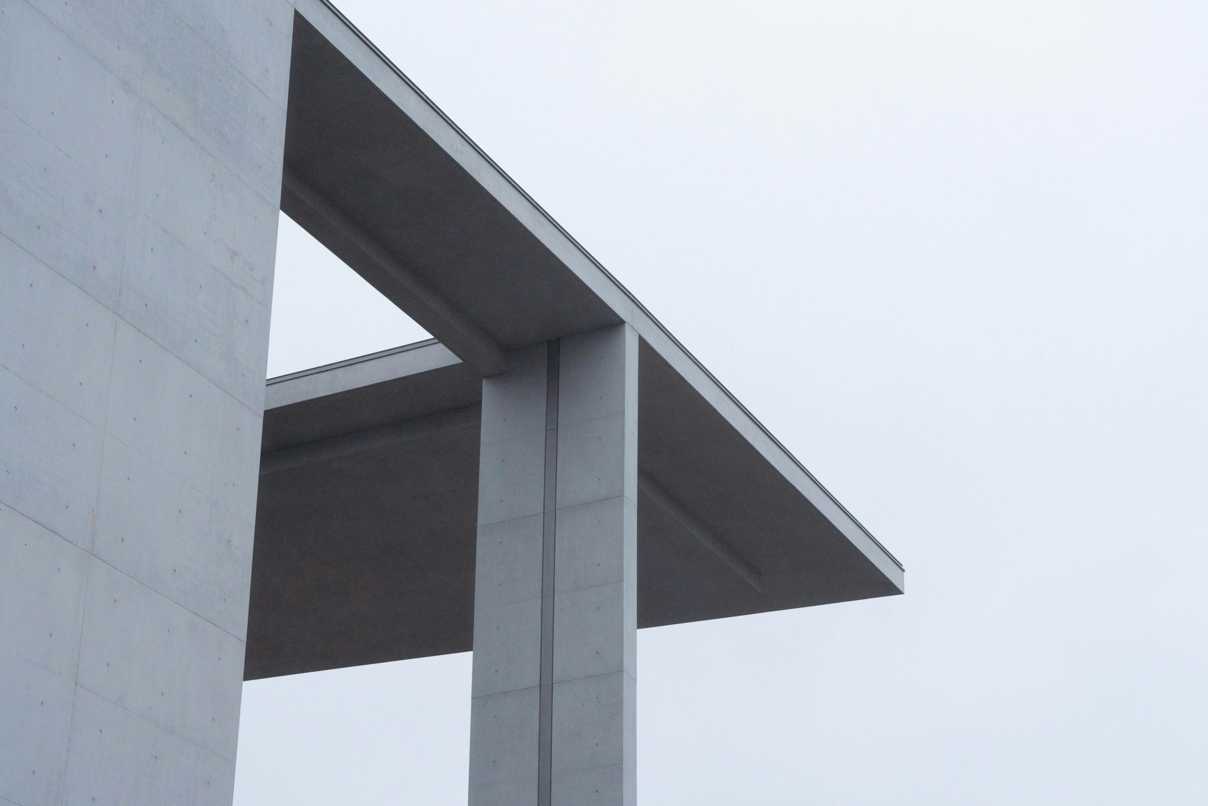 A bird perched on the edge of a building