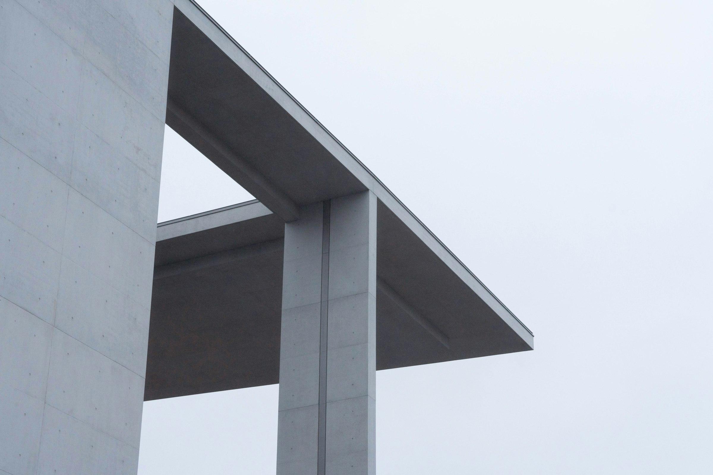 A bird perched on the edge of a building