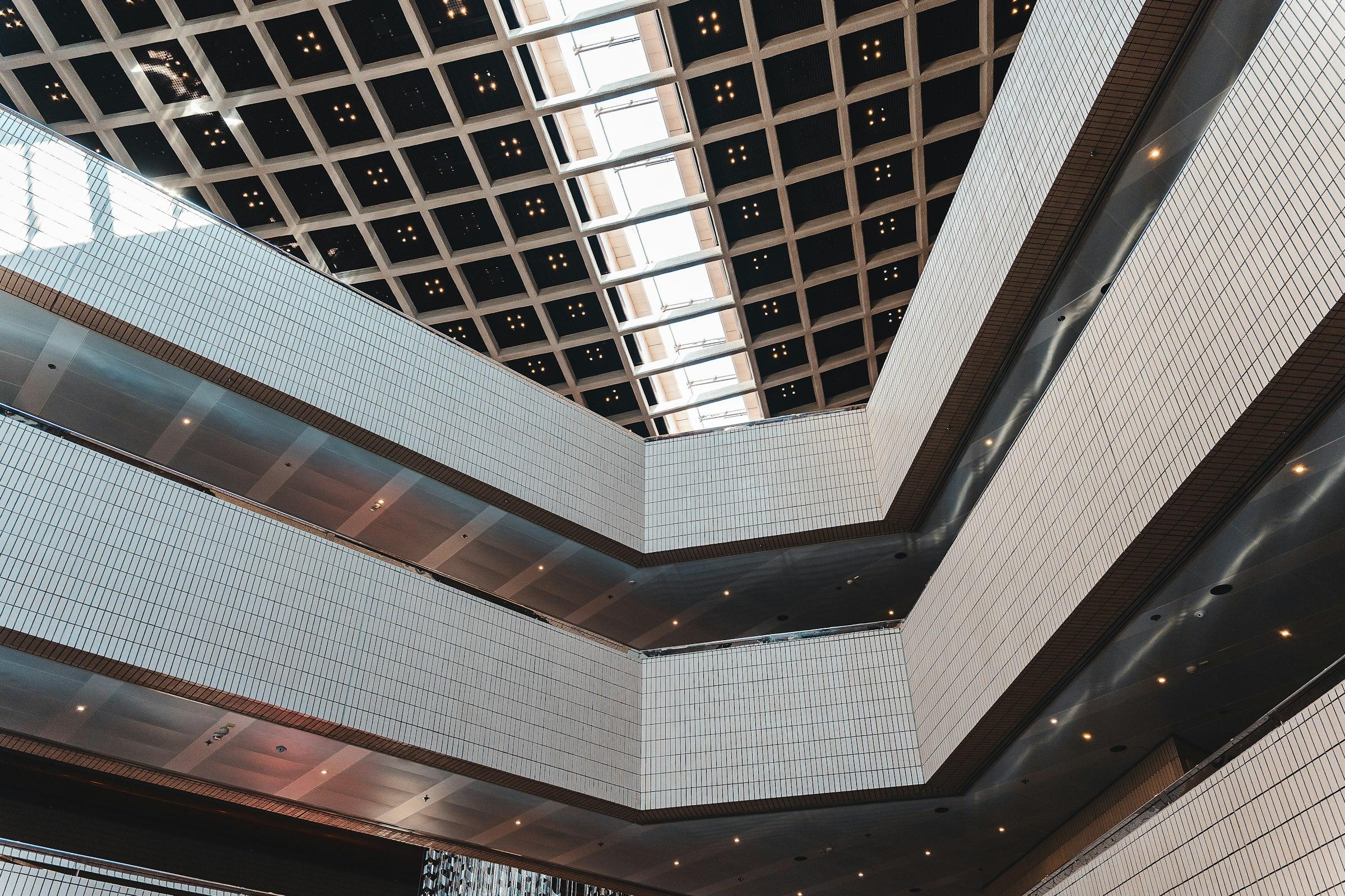 Modern atrium interior with a geometric ceiling