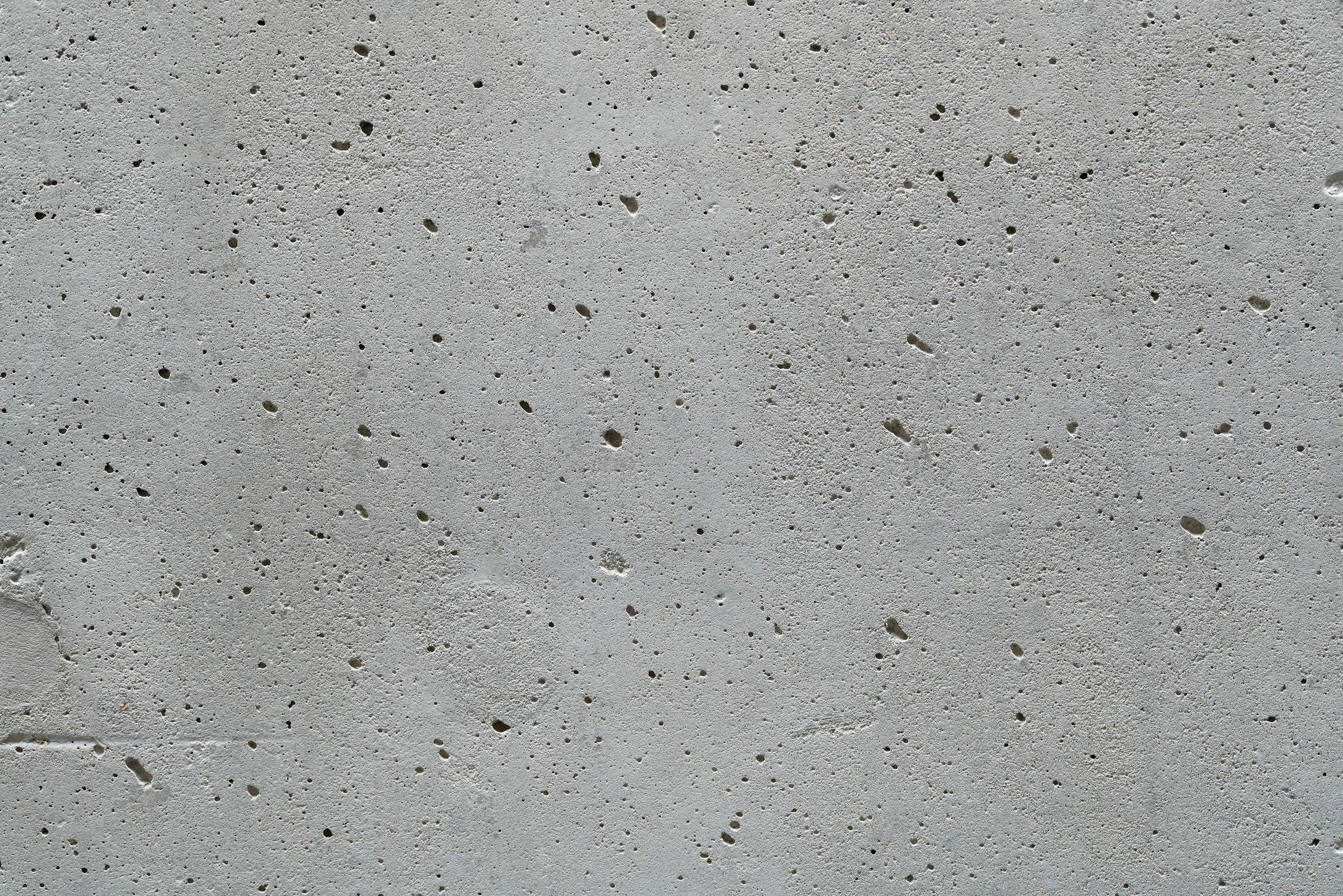 A cast concrete wall with a grid of small openings