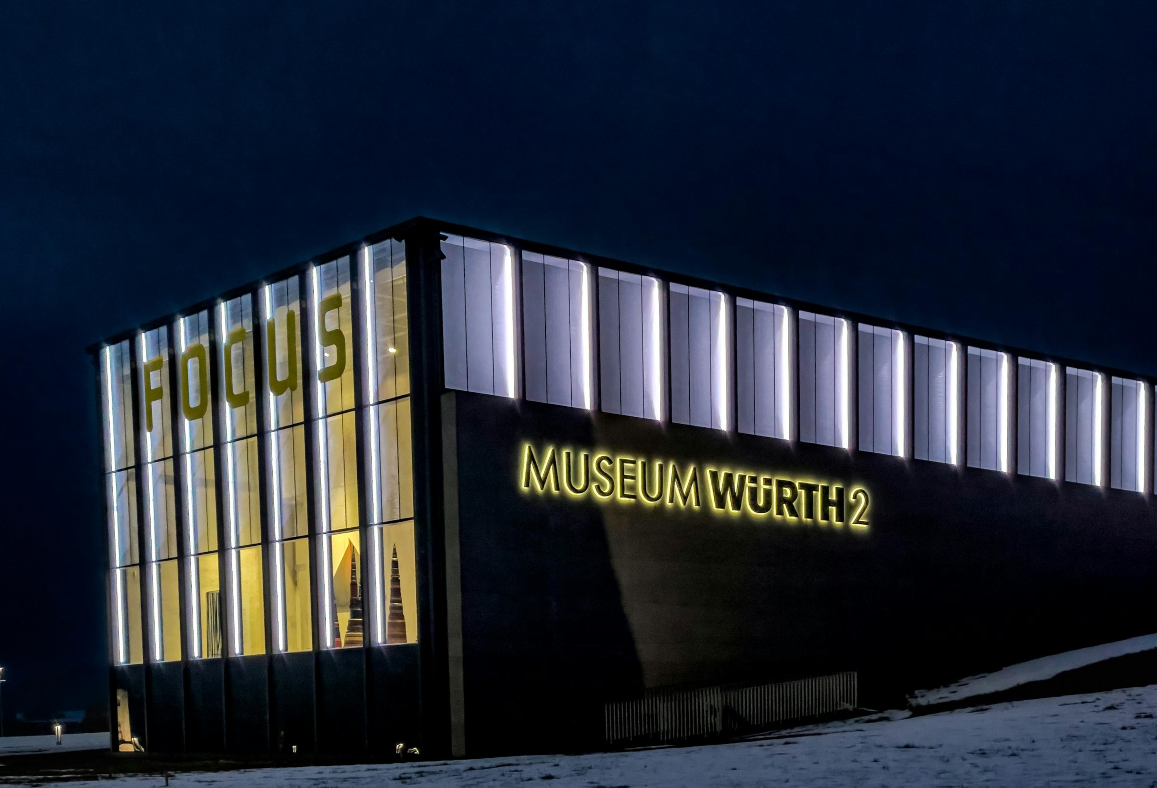 A museum building lit from within at night