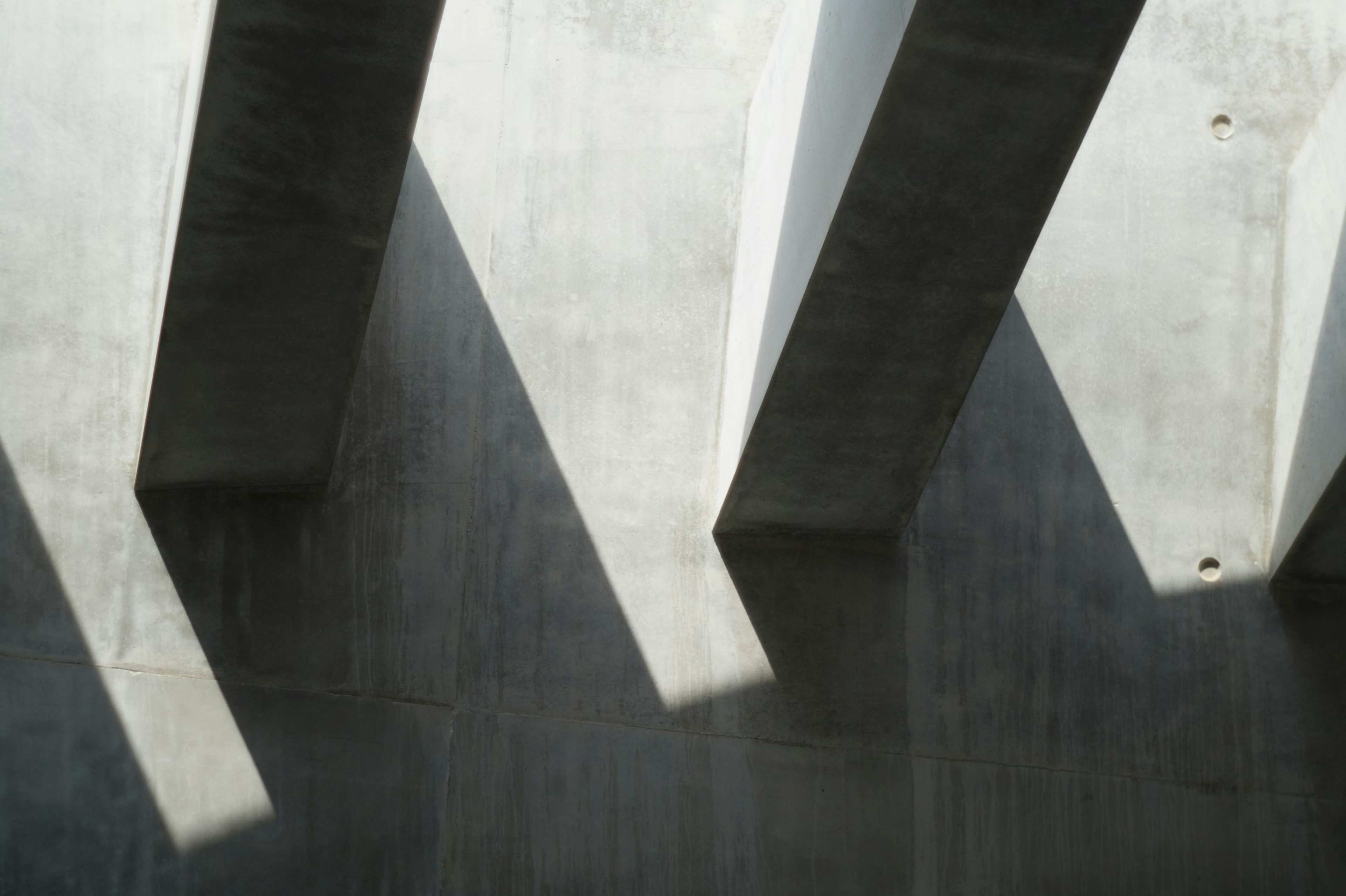 The shadow of a building falling across its own facade