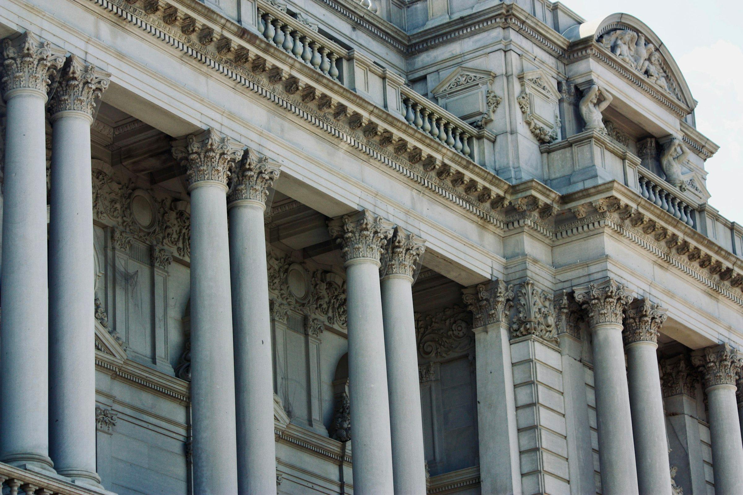 Grand marble building with classical columns and ornate detailing