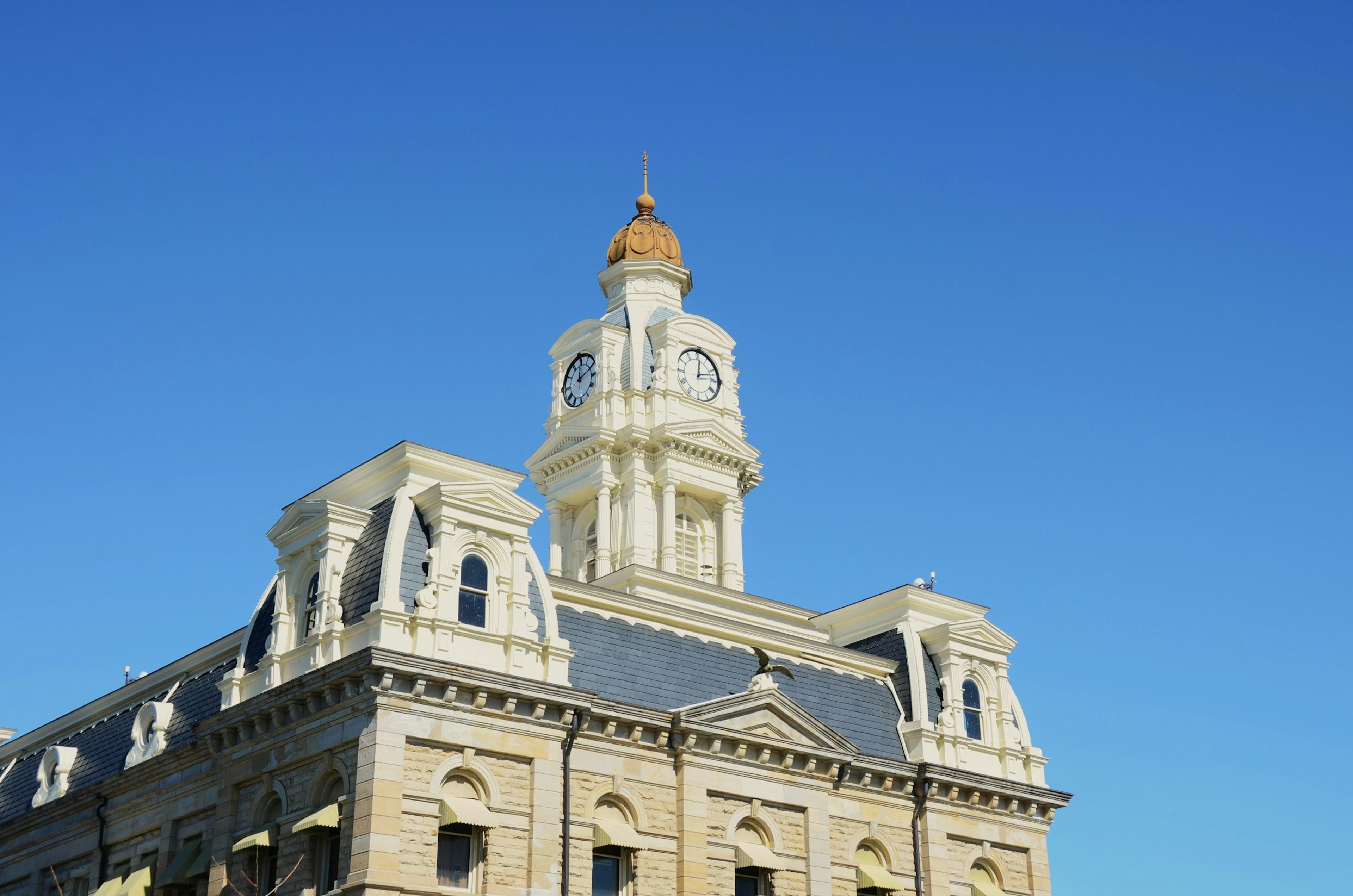 Ornate building with a clock tower against a blue sky