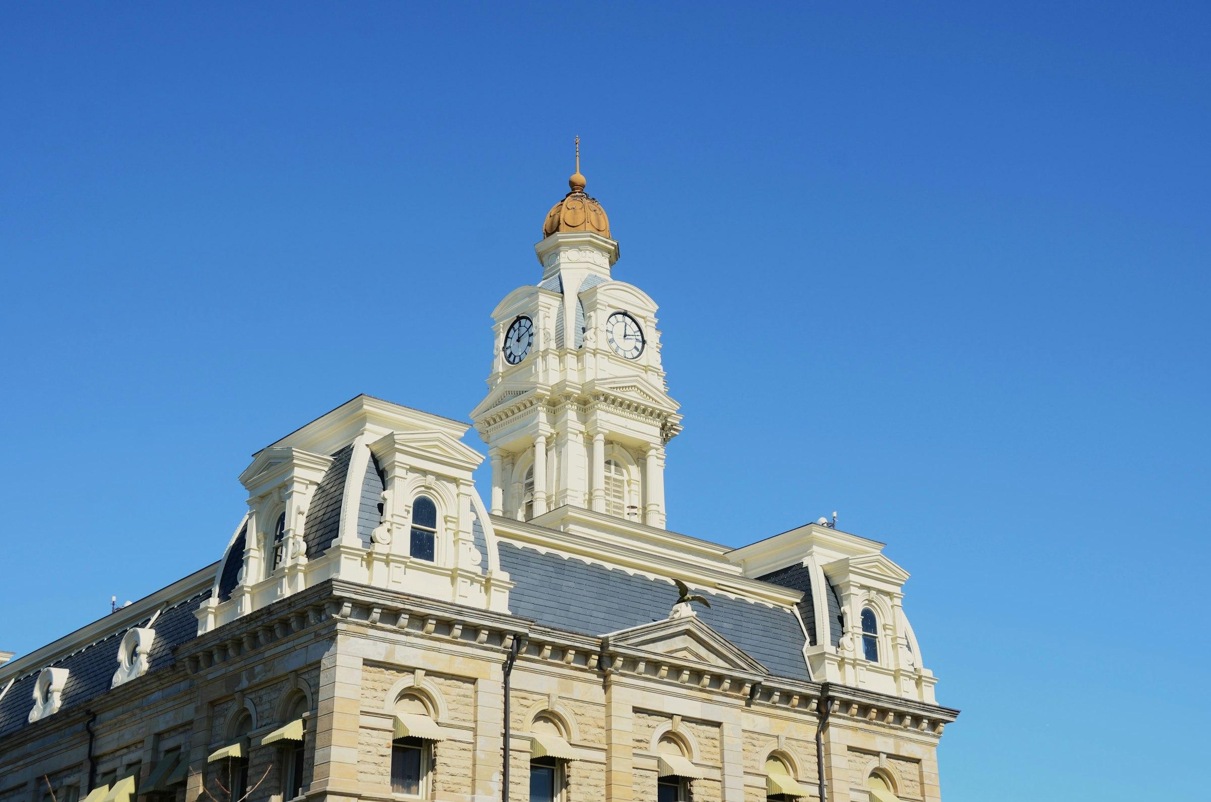 Ornate building with a clock tower against a blue sky